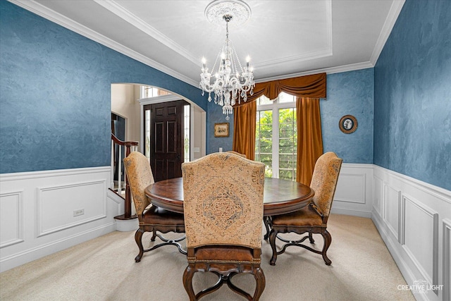 25700 Pastoral Dr, Plainfield, IL 60585 - carpeted dining space with a chandelier, arched walkways, ornamental molding, a decorative wall, and wainscoting