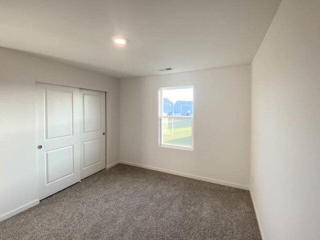 6900 Willow Dr, Wonder Lake, IL 60097 - unfurnished bedroom with carpet floors, baseboards, recessed lighting, and a closet