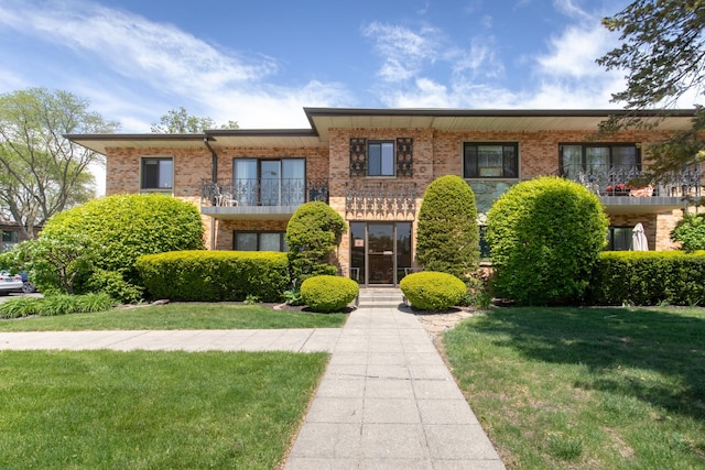 1033 Busse Hwy Unit 1D, Park Ridge, IL 60068 - view of front facade featuring brick siding, a front yard, and a balcony