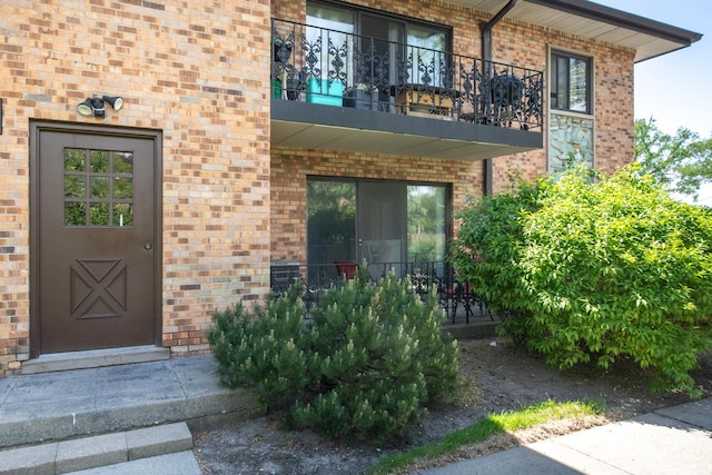 1033 Busse Hwy Unit 1D, Park Ridge, IL 60068 - view of exterior entry with brick siding and a balcony