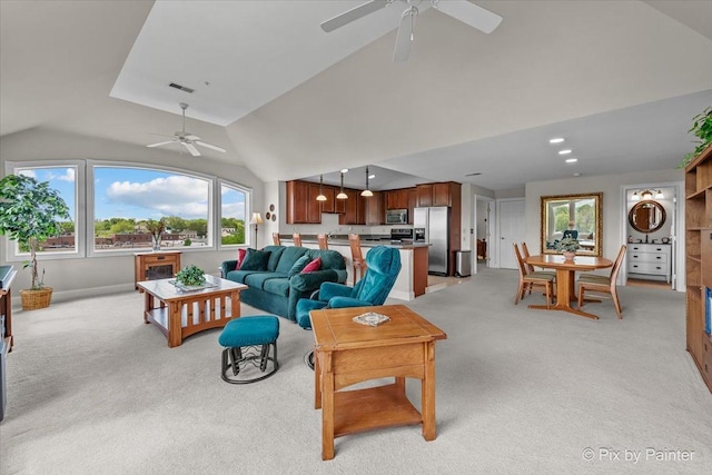 100 N River Ln Unit 409, Geneva, IL 60134 - living room with a ceiling fan, vaulted ceiling, light carpet, and baseboards