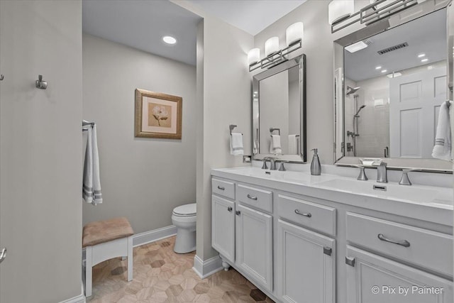 100 N River Ln Unit 409, Geneva, IL 60134 - bathroom featuring a stall shower, double vanity, toilet, baseboards, and recessed lighting