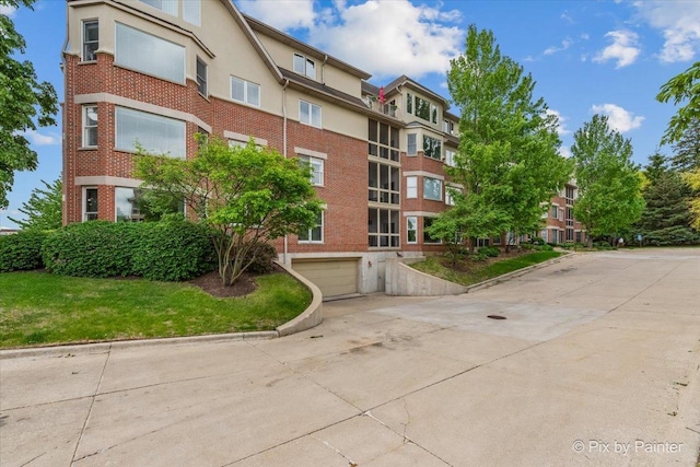 100 N River Ln Unit 409, Geneva, IL 60134 - view of property featuring driveway and an attached garage
