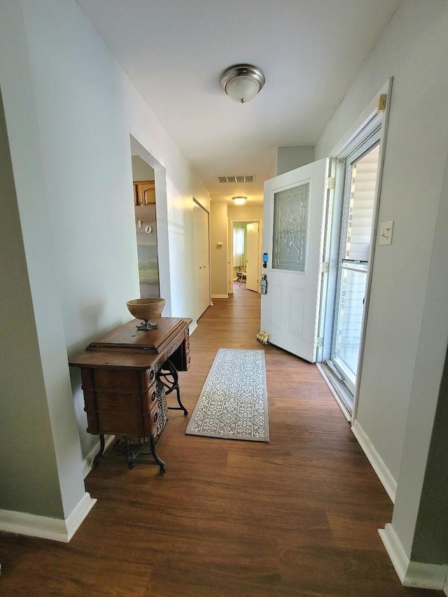 hall with wood finished floors and baseboards