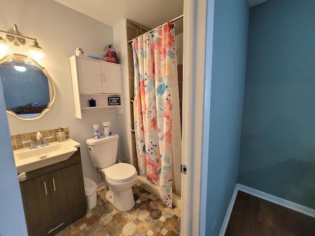 bathroom featuring vanity, toilet, and a shower with curtain