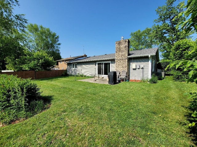 rear view of house with a chimney, a patio area, and central air condition unit
