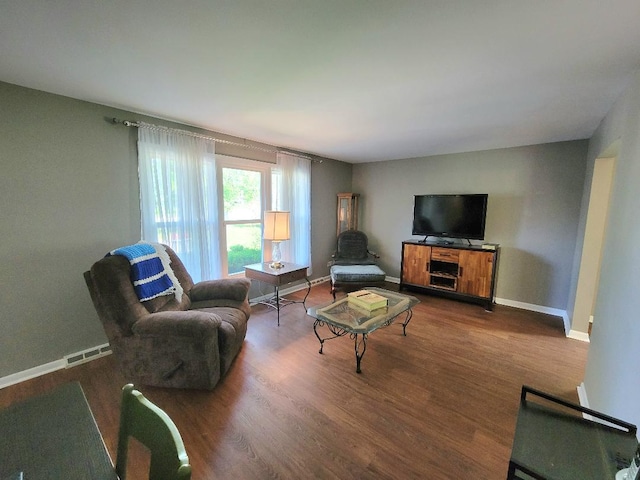 living room featuring wood finished floors and baseboards