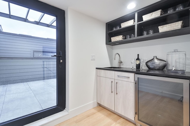 2049 W Race Ave, Chicago, IL 60612 - indoor wet bar with wine cooler, light wood finished floors, and baseboards
