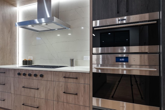 2049 W Race Ave, Chicago, IL 60612 - kitchen with wall chimney exhaust hood, stainless steel double oven, light countertops, modern cabinets, and cooktop