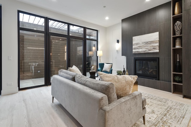 2049 W Race Ave, Chicago, IL 60612 - living room with a large fireplace, light wood finished floors, recessed lighting, and baseboards