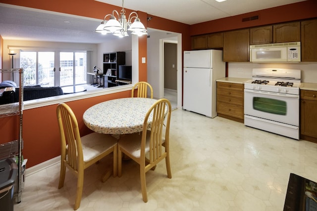 7021 W Touhy Ave Unit 305, Niles, IL 60714 - kitchen featuring white appliances, a chandelier, decorative light fixtures, light countertops, and open floor plan