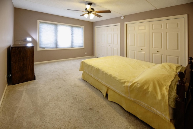7021 W Touhy Ave Unit 305, Niles, IL 60714 - bedroom with multiple closets, baseboards, carpet floors, and a ceiling fan