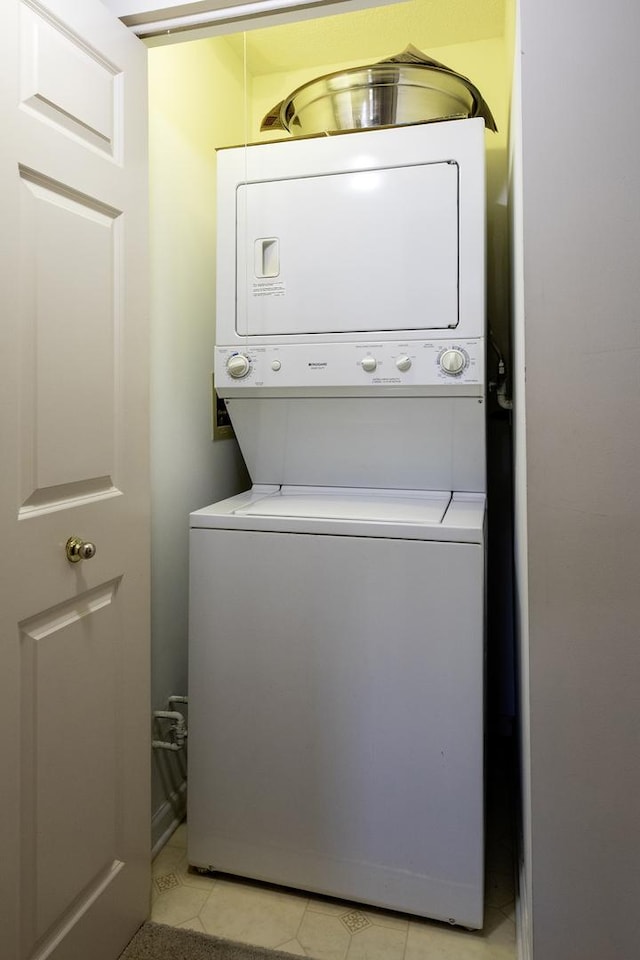 7021 W Touhy Ave Unit 305, Niles, IL 60714 - washroom with stacked washer / drying machine and light tile patterned flooring