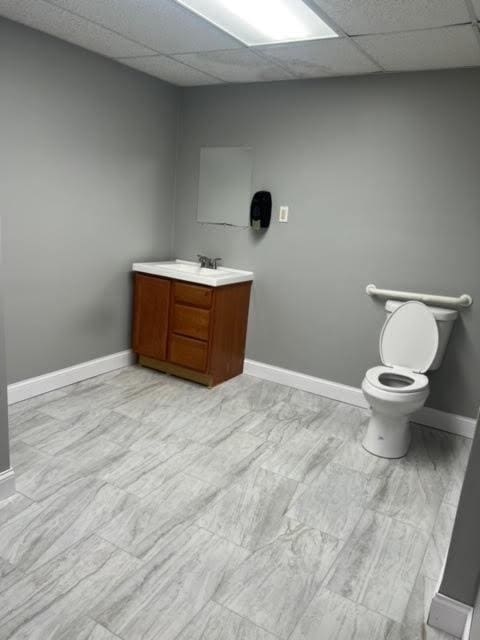 3201 Union Ave, Steger, IL 60475 - bathroom with baseboards, a drop ceiling, toilet, and vanity