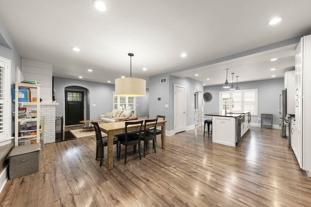24202 W Commercial St, Plainfield, IL 60544 - dining space featuring dark wood finished floors, a brick fireplace, recessed lighting, and baseboards