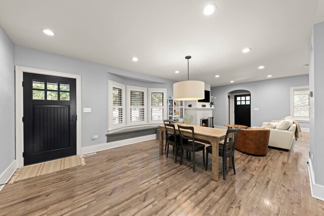 24202 W Commercial St, Plainfield, IL 60544 - dining room featuring a brick fireplace, light wood-style flooring, recessed lighting, and healthy amount of natural light