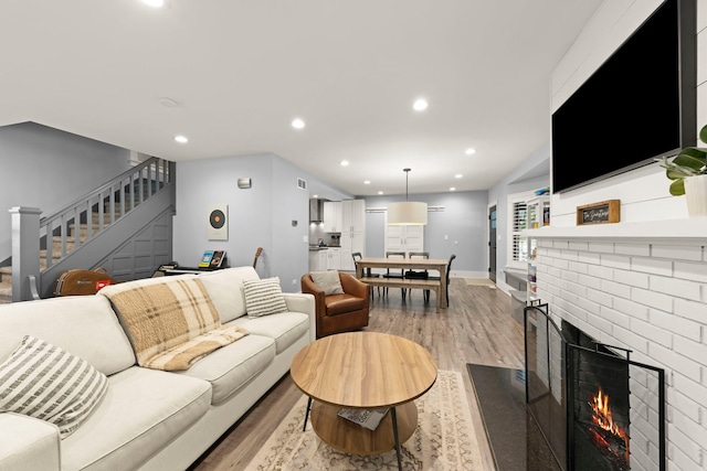 24202 W Commercial St, Plainfield, IL 60544 - living area with light wood-style floors, stairway, recessed lighting, a brick fireplace, and baseboards