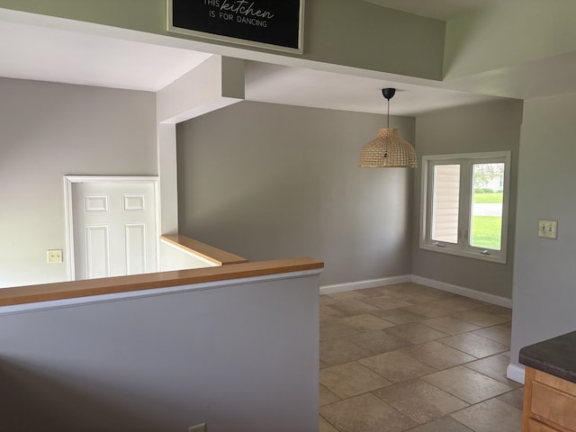 206 E Front St, Granville, IL 61326 - kitchen featuring baseboards, decorative light fixtures, and stone finish flooring