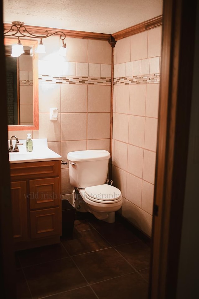 48 Norman St, Kankakee, IL 60901 - bathroom with tile patterned flooring, toilet, vanity, and tile walls