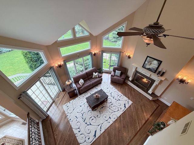 5 Todor Ct, Burr Ridge, IL 60527 - living room featuring high vaulted ceiling, wood finished floors, a glass covered fireplace, ceiling fan, and baseboards