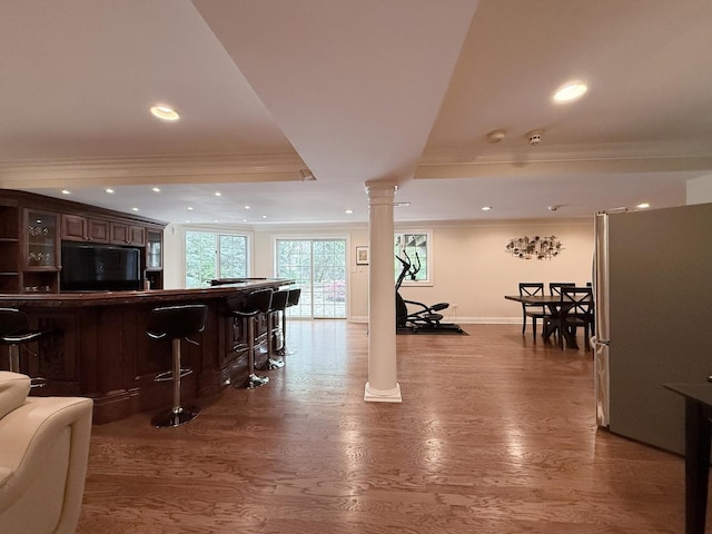 5 Todor Ct, Burr Ridge, IL 60527 - indoor dry bar featuring ornate columns, freestanding refrigerator, crown molding, a raised ceiling, and baseboards