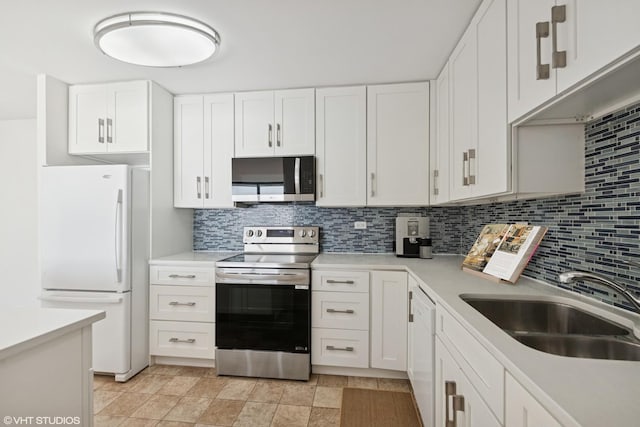 155 N Harbor Dr Unit 610, Chicago, IL 60601 - kitchen featuring appliances with stainless steel finishes, a sink, backsplash, and light countertops