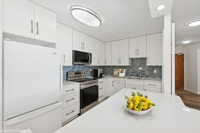 155 N Harbor Dr Unit 610, Chicago, IL 60601 - kitchen with appliances with stainless steel finishes, backsplash, light countertops, and white cabinetry