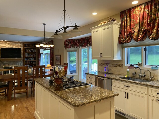 1312 Galloway Dr, Woodstock, IL 60098 - kitchen with a sink, stainless steel appliances, light wood-style floors, plenty of natural light, and recessed lighting