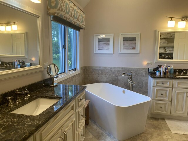 1312 Galloway Dr, Woodstock, IL 60098 - bathroom with tile walls, a soaking tub, tile patterned flooring, vanity, and a wainscoted wall