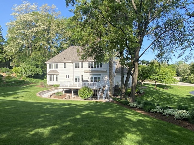 1312 Galloway Dr, Woodstock, IL 60098 - rear view of house featuring a deck, a lawn, and stairs