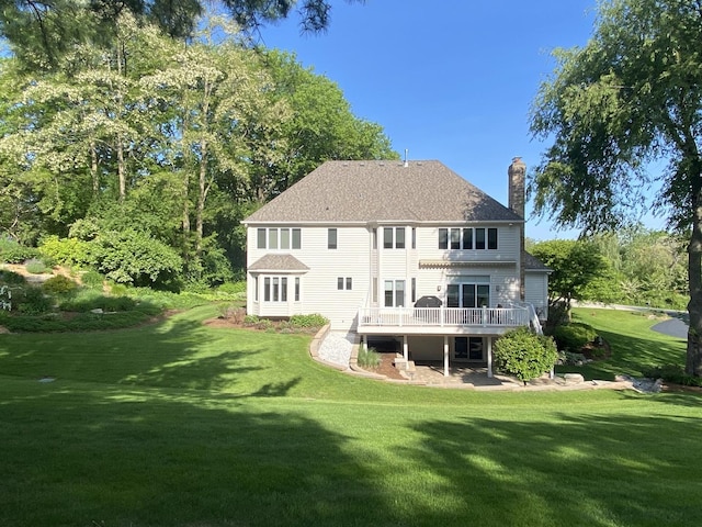 1312 Galloway Dr, Woodstock, IL 60098 - rear view of house with a chimney, a deck, a yard, and roof with shingles