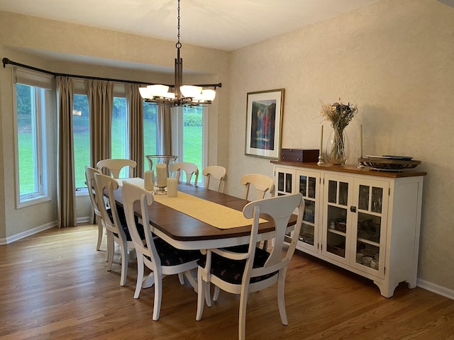 1312 Galloway Dr, Woodstock, IL 60098 - dining area featuring wood finished floors, a chandelier, and baseboards