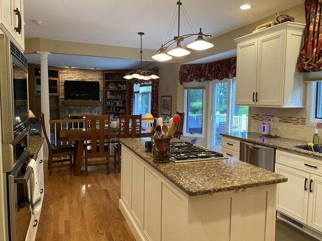 1312 Galloway Dr, Woodstock, IL 60098 - kitchen with light wood-type flooring, a center island, recessed lighting, stainless steel appliances, and stone countertops