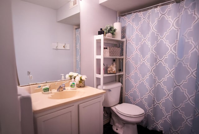 full bathroom with toilet and vanity