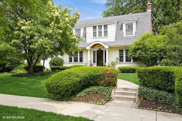 944 Fair Oaks Ave, Oak Park, IL 60302 - colonial inspired home featuring a chimney, a front lawn, and roof with shingles