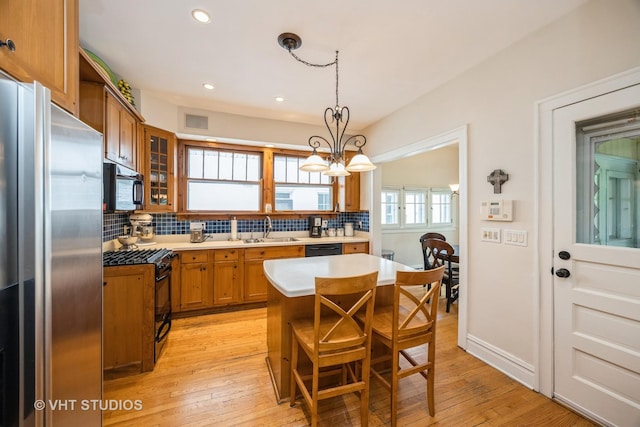 944 Fair Oaks Ave, Oak Park, IL 60302 - kitchen with black appliances, brown cabinets, tasteful backsplash, and recessed lighting