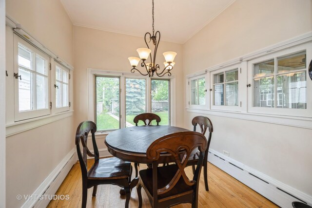 944 Fair Oaks Ave, Oak Park, IL 60302 - dining room with a baseboard heating unit, crown molding, light wood-style floors, a chandelier, and plenty of natural light