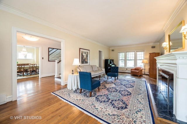 944 Fair Oaks Ave, Oak Park, IL 60302 - living area with wood finished floors, baseboard heating, crown molding, stairway, and a baseboard radiator