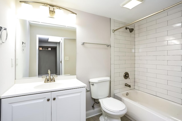 bathroom featuring toilet, vanity,  shower combination, and baseboards