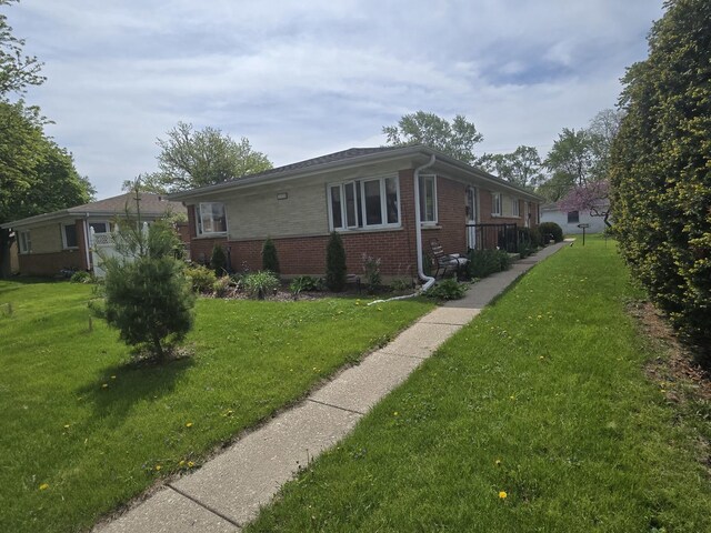 215-217 E Vermont St, Villa Park, IL 60181 - view of side of home featuring brick siding and a yard