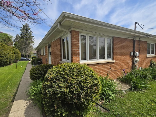 215-217 E Vermont St, Villa Park, IL 60181 - view of property exterior featuring brick siding and a lawn