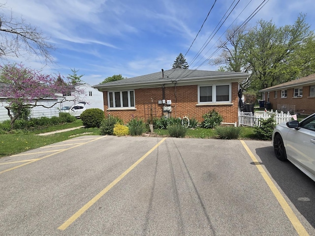 215-217 E Vermont St, Villa Park, IL 60181 - view of front of home featuring uncovered parking, brick siding, and fence