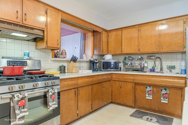 4536 W 79th Pl, Chicago, IL 60652 - kitchen with appliances with stainless steel finishes, under cabinet range hood, tasteful backsplash, and a sink
