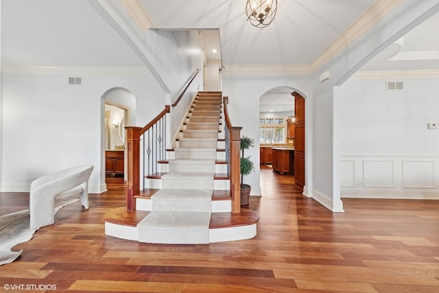 210 S Prospect St, Clarendon Hills, IL 60514 - entryway featuring arched walkways, wood finished floors, stairway, and ornamental molding