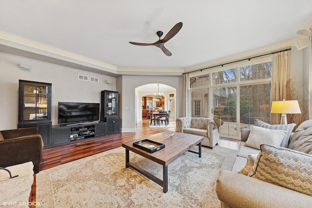 210 S Prospect St, Clarendon Hills, IL 60514 - living area featuring arched walkways, wood finished floors, crown molding, a ceiling fan, and baseboards