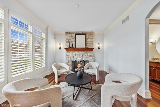210 S Prospect St, Clarendon Hills, IL 60514 - sitting room with crown molding, a stone fireplace, arched walkways, wood finished floors, and baseboards