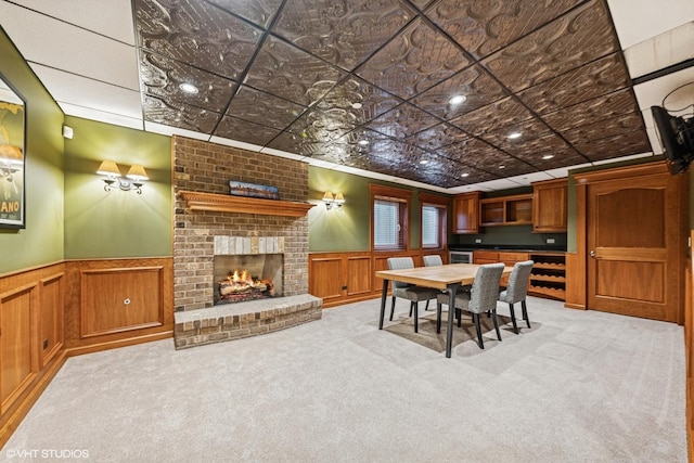 210 S Prospect St, Clarendon Hills, IL 60514 - dining space with a fireplace, carpet floors, a wainscoted wall, an ornate ceiling, and a decorative wall