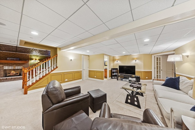 210 S Prospect St, Clarendon Hills, IL 60514 - carpeted living area with a fireplace, stairway, a wainscoted wall, and a drop ceiling