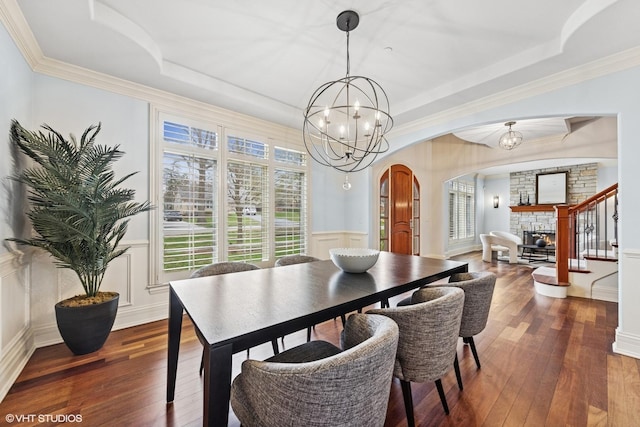 210 S Prospect St, Clarendon Hills, IL 60514 - dining space with arched walkways, hardwood / wood-style floors, a tray ceiling, wainscoting, and a chandelier