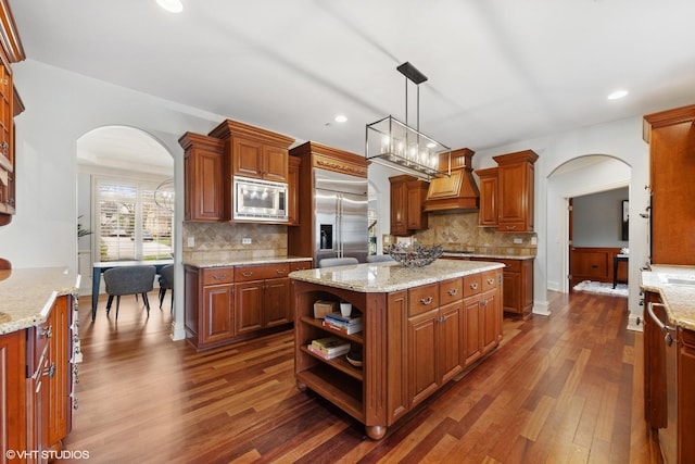 210 S Prospect St, Clarendon Hills, IL 60514 - kitchen with built in appliances, arched walkways, custom exhaust hood, dark wood-type flooring, and recessed lighting